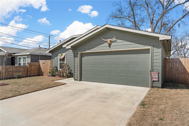 view of front of property featuring a garage and fence