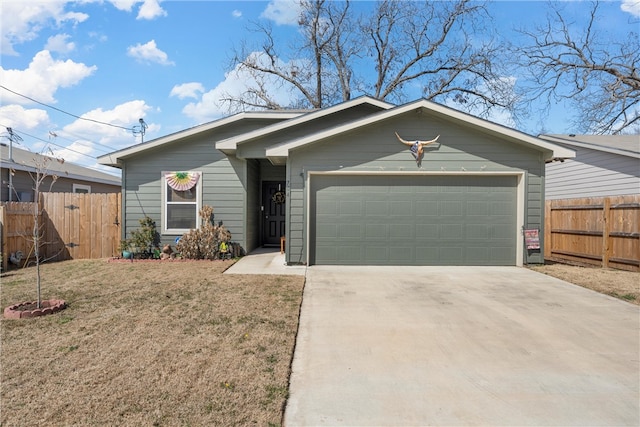 view of front facade featuring a front lawn, fence, driveway, and an attached garage