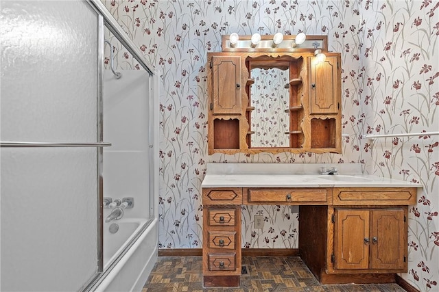 bathroom featuring vanity and bath / shower combo with glass door