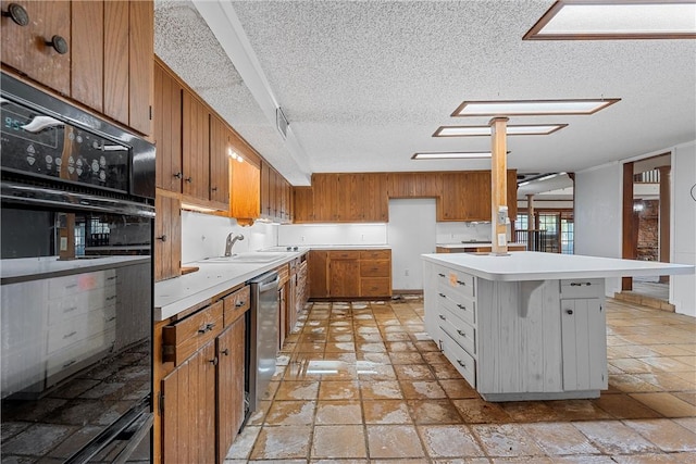 kitchen with sink, stainless steel dishwasher, a textured ceiling, black oven, and a breakfast bar area