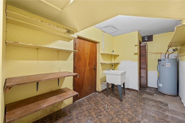 basement featuring dark parquet floors and water heater