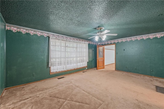 unfurnished bedroom with ceiling fan, carpet, and a textured ceiling