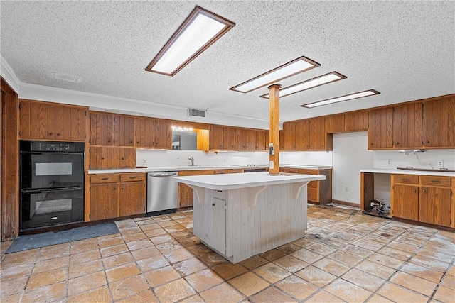 kitchen with stainless steel dishwasher, a center island, a textured ceiling, and double oven