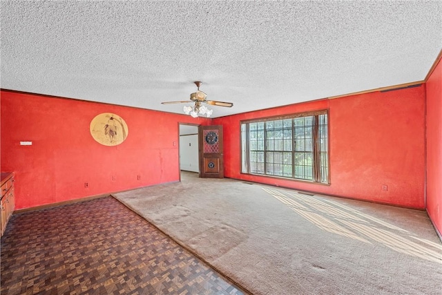 unfurnished room featuring ceiling fan and a textured ceiling