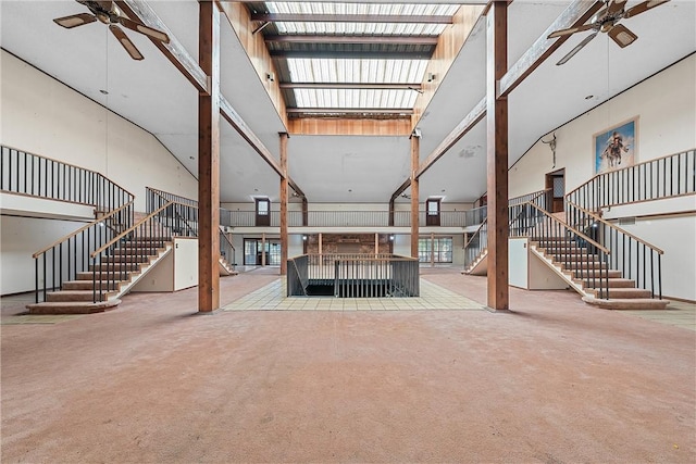 unfurnished living room featuring carpet floors and a high ceiling