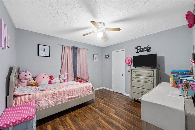 bedroom with ceiling fan, dark hardwood / wood-style flooring, and a textured ceiling