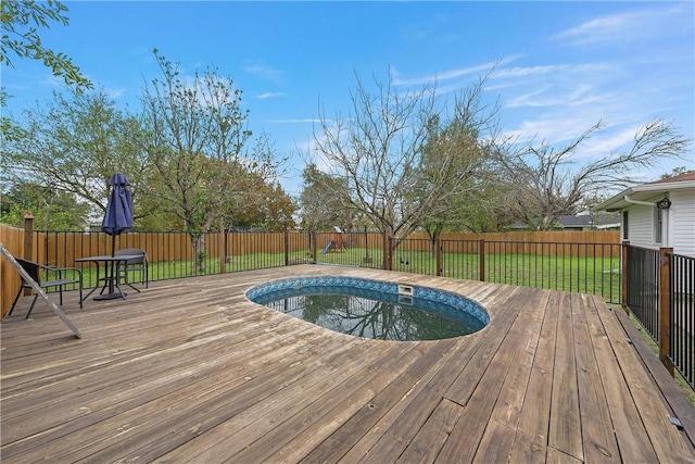 view of swimming pool with a deck and a lawn