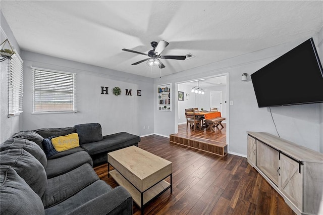 living room featuring ceiling fan and dark hardwood / wood-style floors