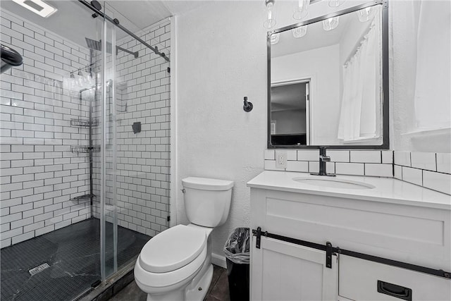 bathroom with decorative backsplash, vanity, toilet, and an enclosed shower