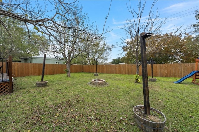 view of yard featuring an outdoor fire pit