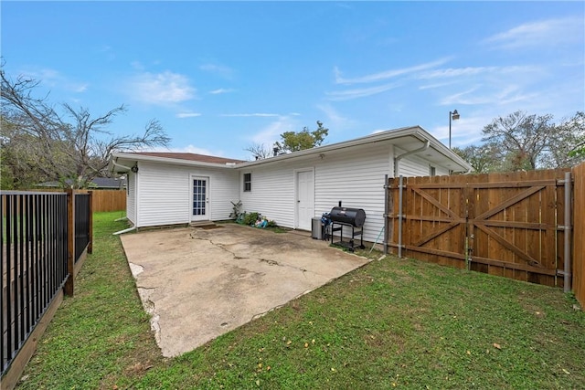 back of property featuring a yard and a patio area