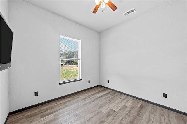 spare room featuring ceiling fan and light hardwood / wood-style flooring