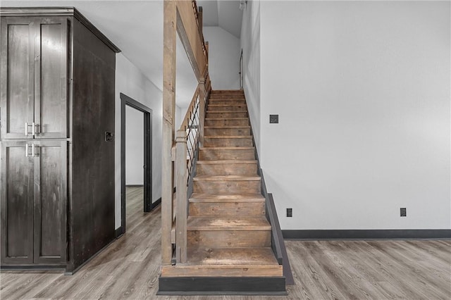 stairs with hardwood / wood-style floors