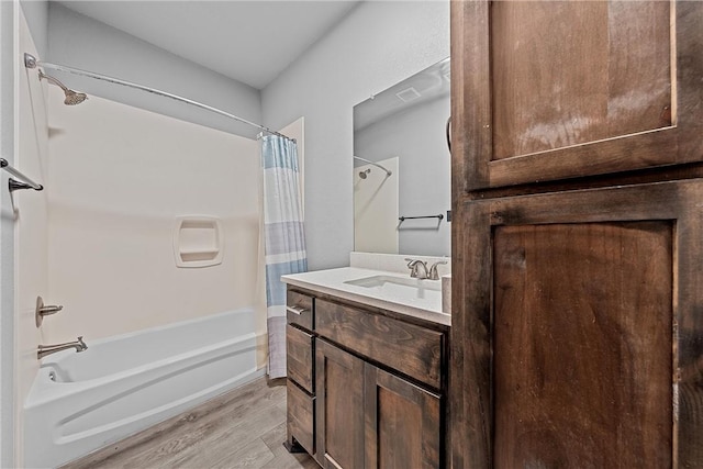 bathroom with hardwood / wood-style floors, vanity, and shower / bath combination with curtain