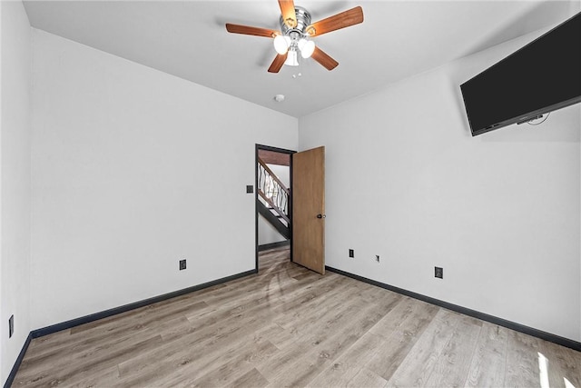 unfurnished room featuring ceiling fan and light hardwood / wood-style flooring