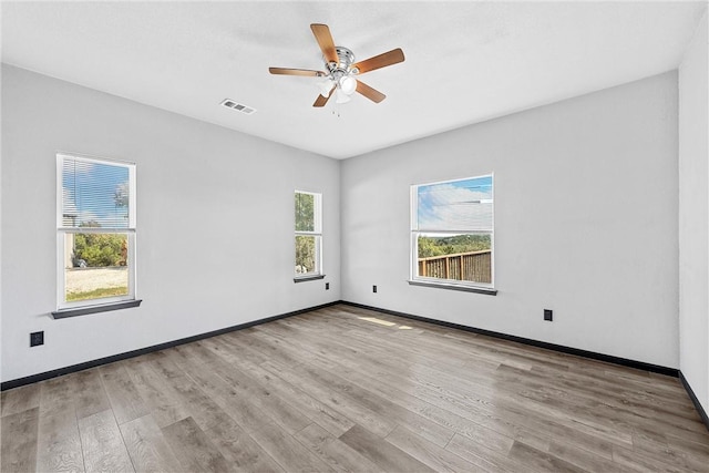 unfurnished room with ceiling fan and light wood-type flooring