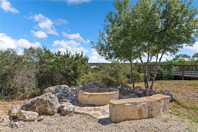 view of yard with a fire pit and a wooden deck