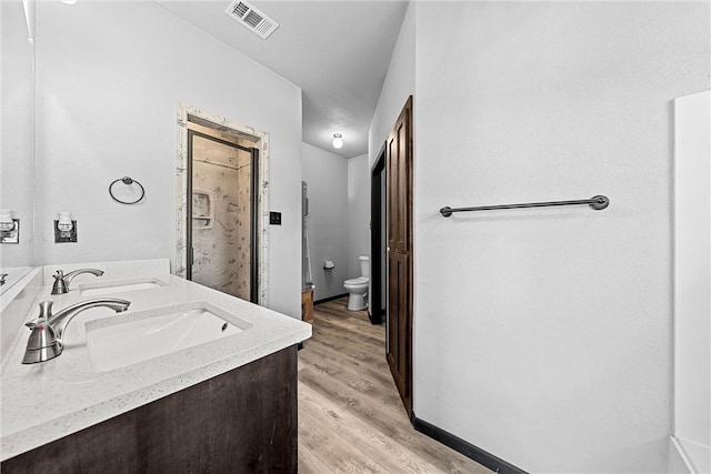 bathroom featuring vanity, hardwood / wood-style flooring, and toilet