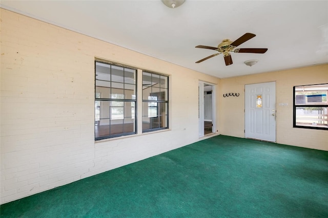 interior space featuring carpet flooring and ceiling fan