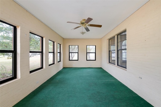 unfurnished sunroom with plenty of natural light and ceiling fan