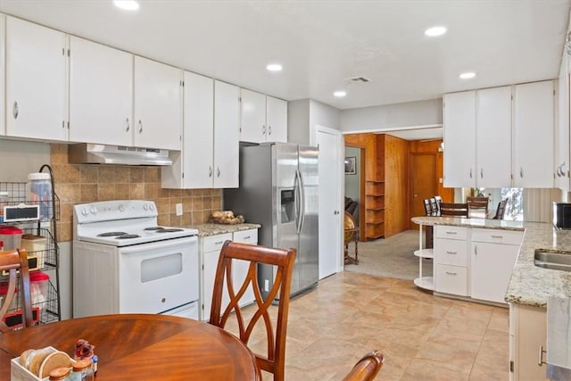 kitchen featuring white electric range oven, stainless steel fridge, white cabinets, and ventilation hood