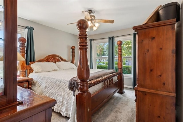 bedroom with ceiling fan and light colored carpet