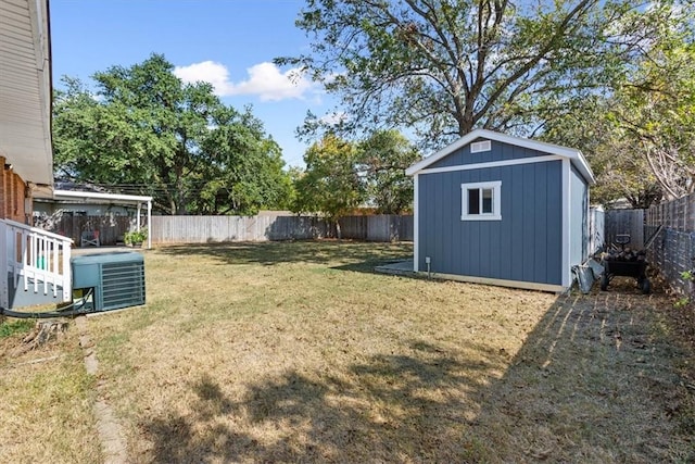 view of yard with cooling unit and a shed