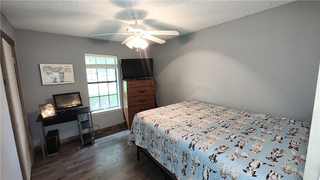 bedroom featuring ceiling fan, dark hardwood / wood-style flooring, and a textured ceiling