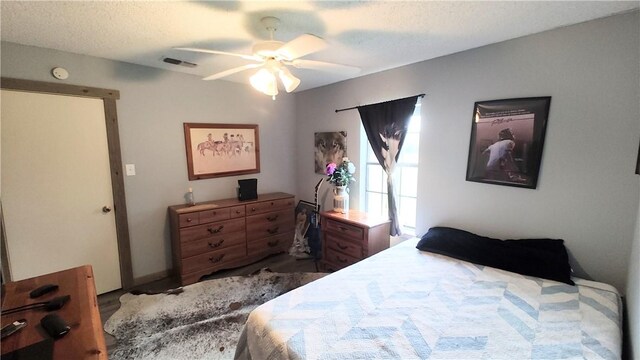 bedroom with a textured ceiling and ceiling fan