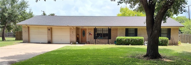 ranch-style house featuring a garage and a front yard