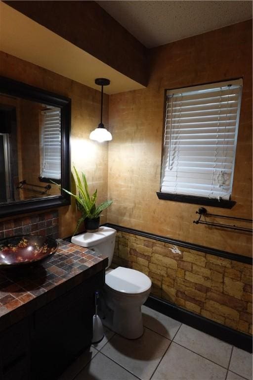 bathroom with tile patterned floors, vanity, and toilet