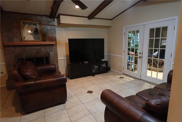 living room featuring vaulted ceiling with beams, light tile patterned floors, a fireplace, and french doors