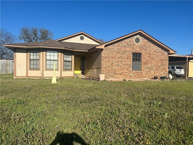 ranch-style house featuring brick siding, a front lawn, and fence