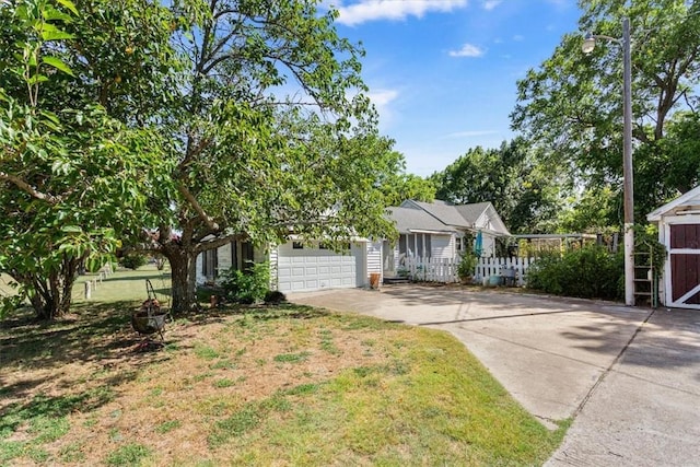 view of front of house featuring a garage and a front lawn