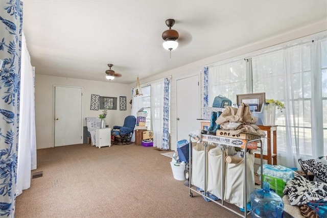 misc room with ceiling fan and carpet floors