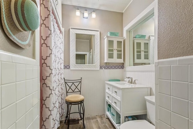 bathroom featuring hardwood / wood-style flooring, vanity, toilet, and walk in shower