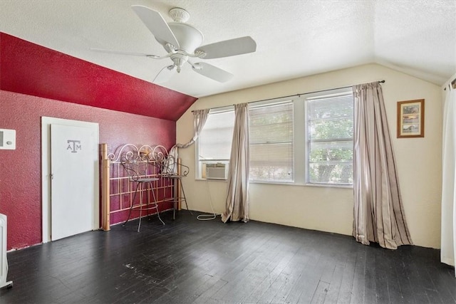 additional living space featuring ceiling fan, dark hardwood / wood-style flooring, a textured ceiling, and vaulted ceiling