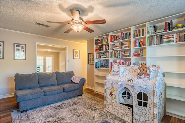 living area featuring ceiling fan, french doors, a textured ceiling, and hardwood / wood-style flooring