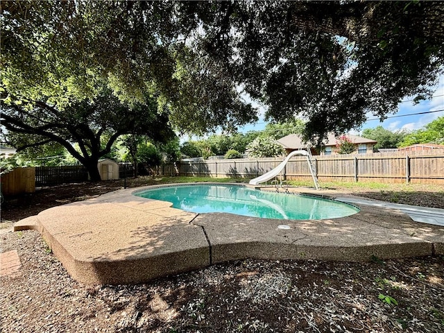 view of pool featuring a storage unit and a water slide