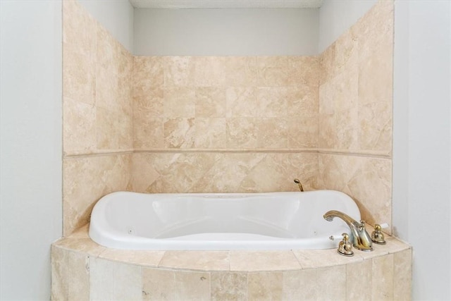 bathroom with a relaxing tiled tub