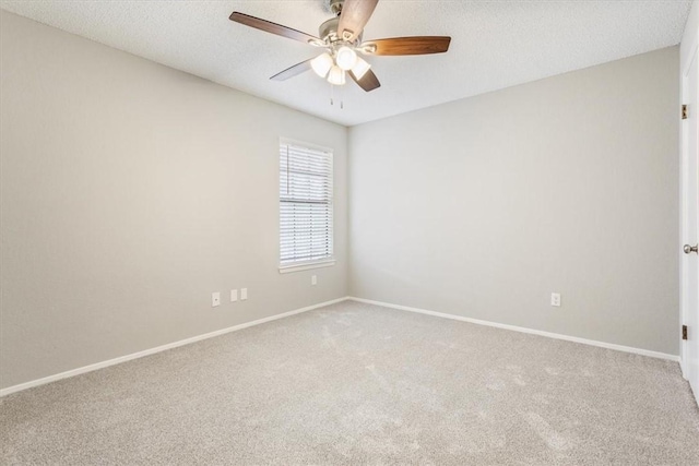 spare room featuring carpet flooring, ceiling fan, and a textured ceiling