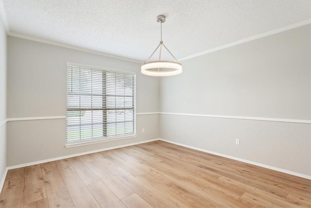 unfurnished room featuring hardwood / wood-style flooring, crown molding, and a textured ceiling