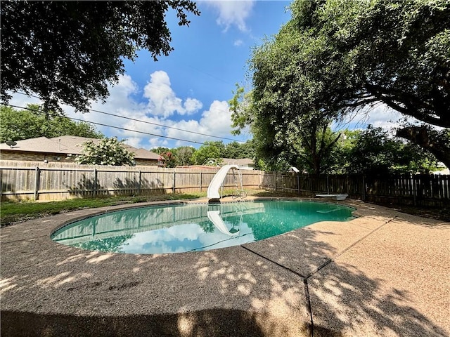 view of pool featuring a patio, a diving board, and a water slide