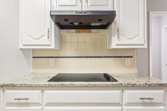 kitchen with white cabinets, decorative backsplash, and black electric cooktop