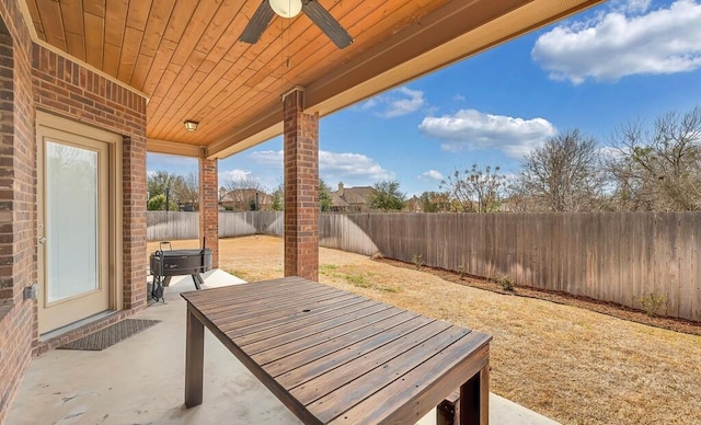 view of patio with a fenced backyard and a ceiling fan