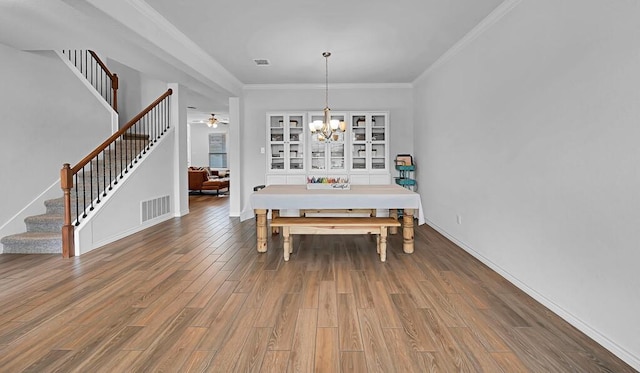 dining space featuring ornamental molding, visible vents, stairway, and wood finished floors