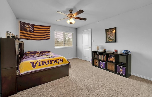 carpeted bedroom with baseboards and a ceiling fan