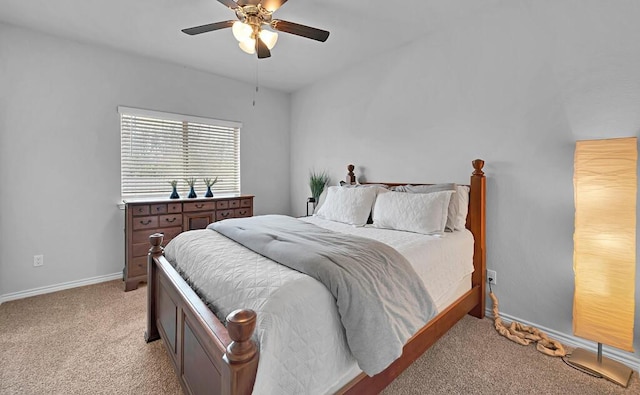 bedroom with ceiling fan, baseboards, and light colored carpet