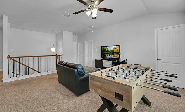 playroom with carpet floors, visible vents, vaulted ceiling, and a ceiling fan