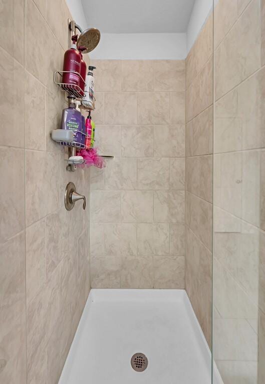 full bath with a tile shower